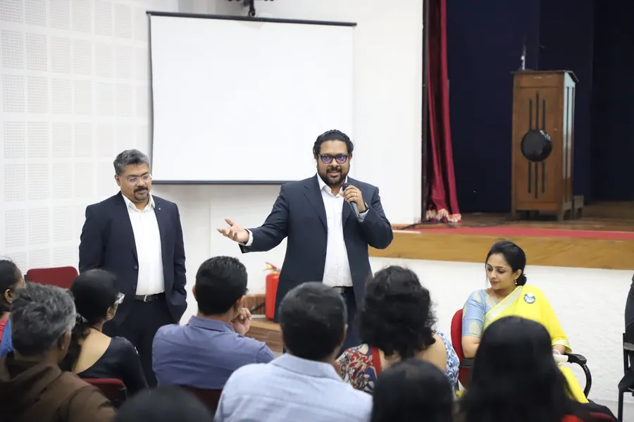 A VentureVillage co-founder speaking to an audience of teachers, with the other co-founder standing beside him.
